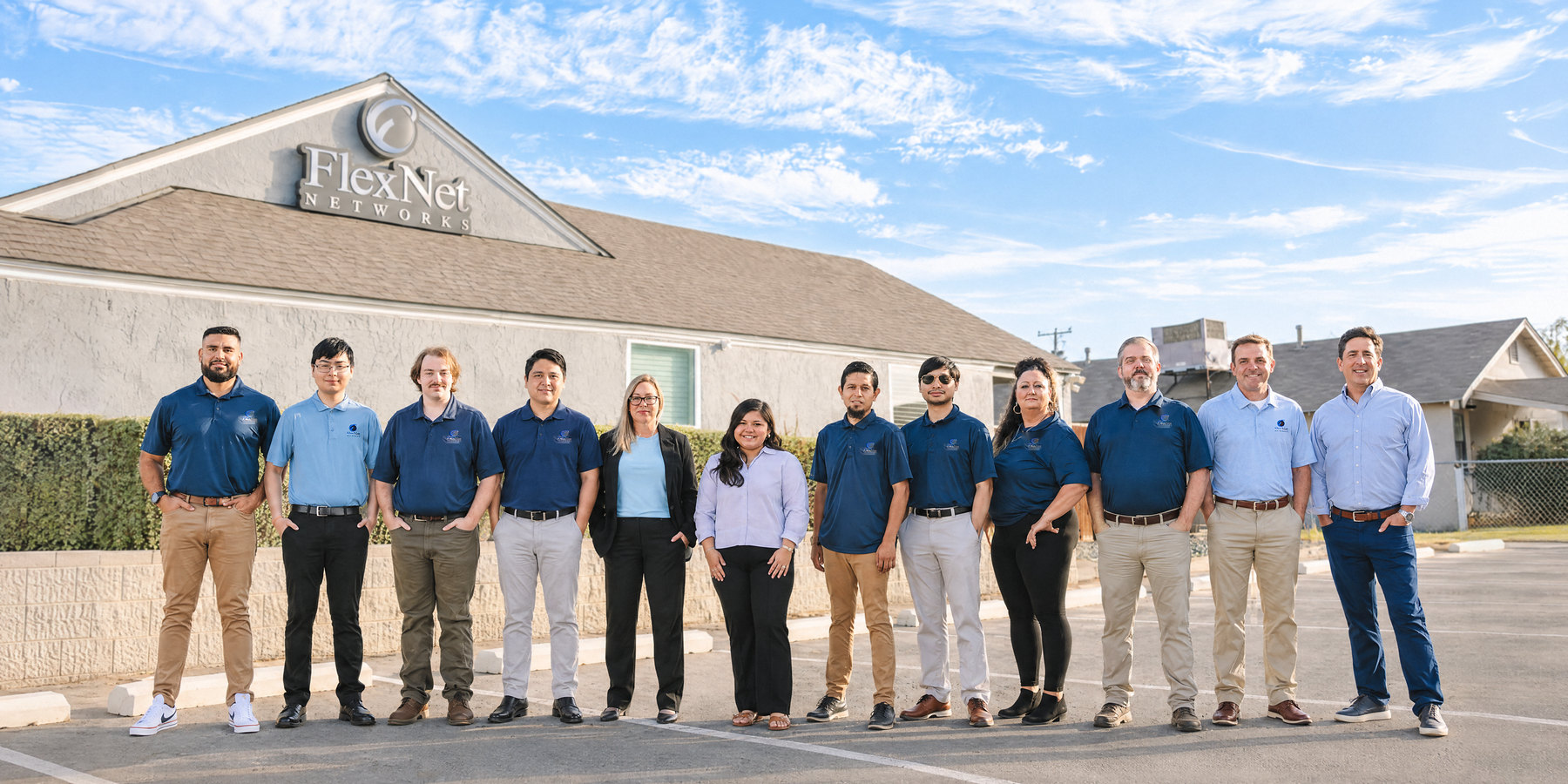 The Flexnet Networks team standing together outside the Flexnet Networks office